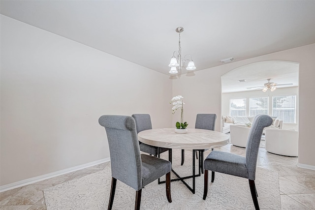 dining room with ceiling fan with notable chandelier