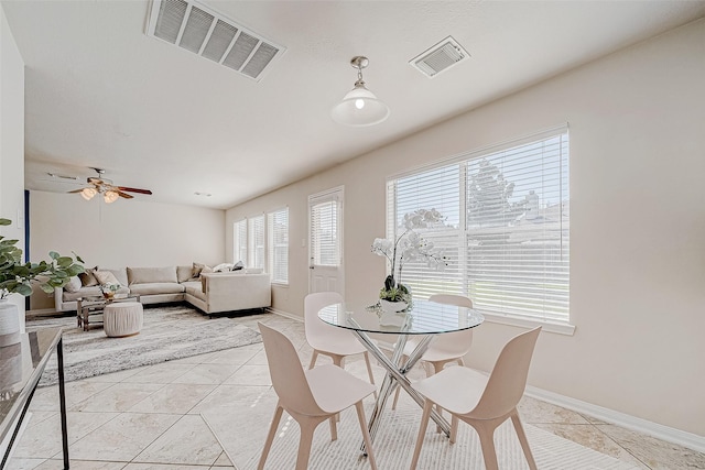 dining area with ceiling fan and light tile patterned flooring