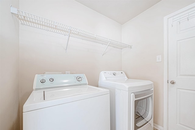 washroom with independent washer and dryer