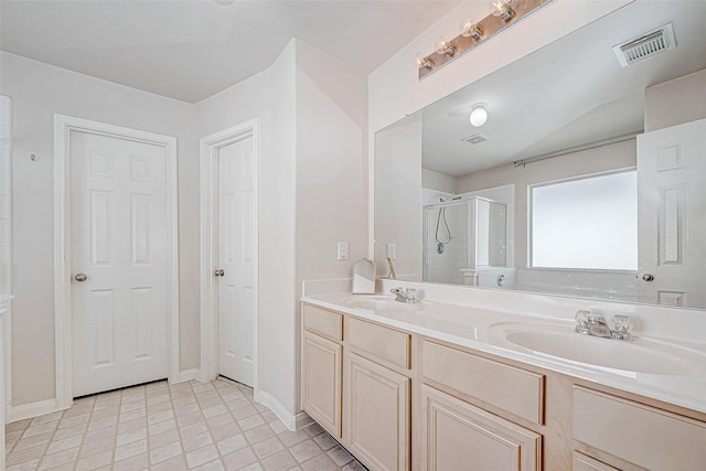 bathroom featuring vanity and a shower with shower door