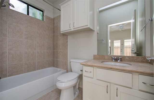 full bathroom with vanity, ceiling fan, tile patterned flooring, toilet, and tiled shower / bath