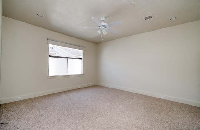 carpeted spare room featuring ceiling fan