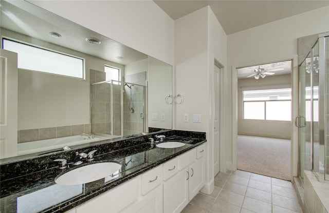 bathroom featuring tile patterned floors, plus walk in shower, vanity, and a healthy amount of sunlight