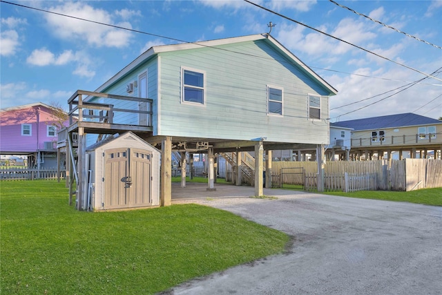 exterior space with a storage shed, a front yard, and a carport