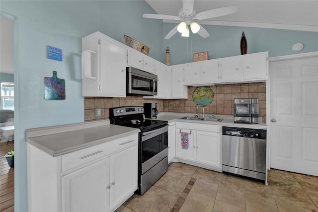 kitchen with white cabinets, stainless steel appliances, tasteful backsplash, and sink