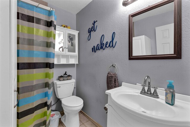 bathroom featuring tile patterned floors, toilet, sink, and a shower with shower curtain