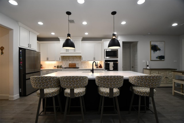 kitchen with a kitchen island with sink, sink, white cabinets, and stainless steel appliances