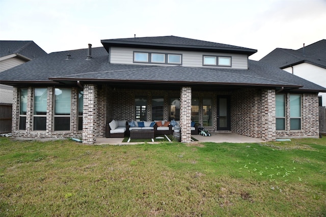 rear view of property with a yard, an outdoor hangout area, and a patio