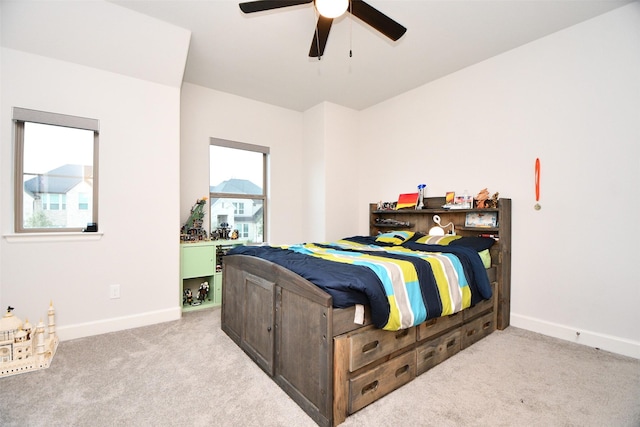 bedroom featuring ceiling fan and light carpet