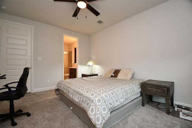 bedroom with carpet flooring, ensuite bath, and ceiling fan