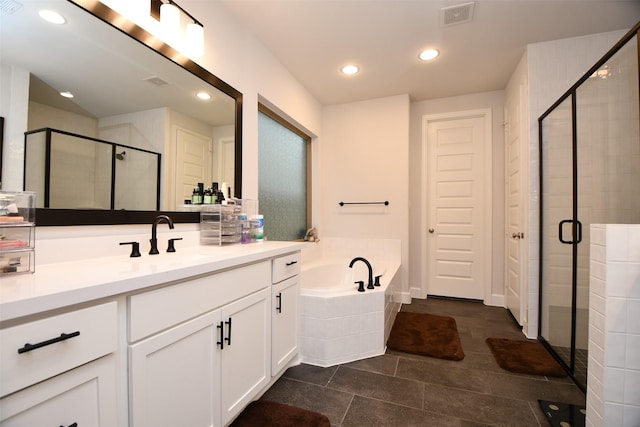 bathroom with tile patterned floors, vanity, and independent shower and bath