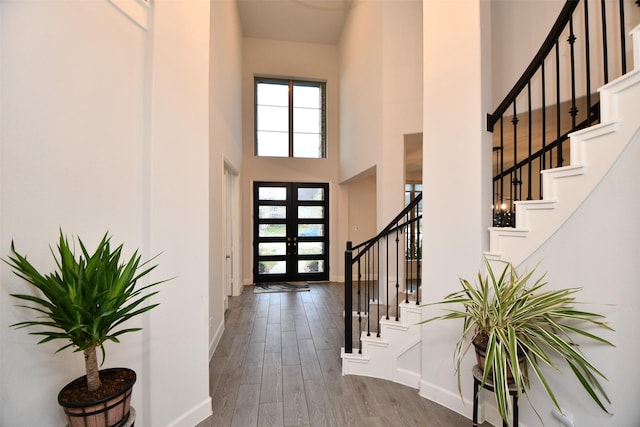 entryway featuring french doors, a high ceiling, and hardwood / wood-style flooring