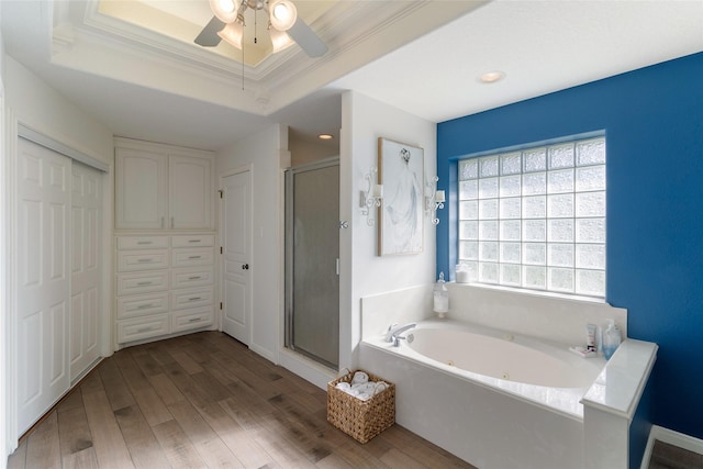 bathroom featuring ceiling fan, a raised ceiling, separate shower and tub, crown molding, and hardwood / wood-style floors