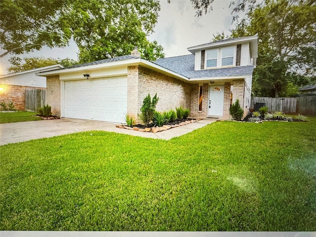 view of front facade with a garage and a front lawn