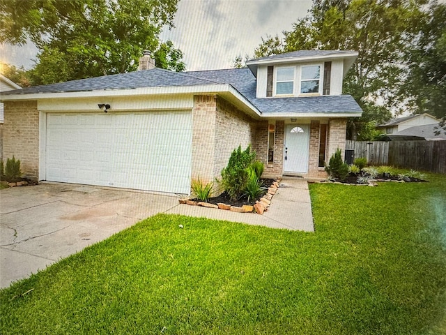 view of front of house with a garage and a front lawn