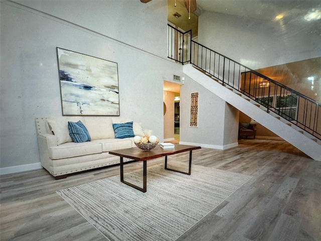 living room featuring hardwood / wood-style floors and a high ceiling