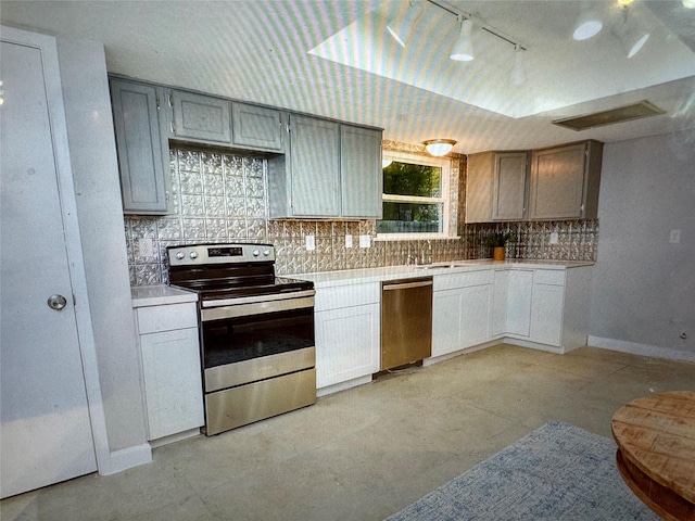 kitchen featuring gray cabinetry, decorative backsplash, sink, and appliances with stainless steel finishes