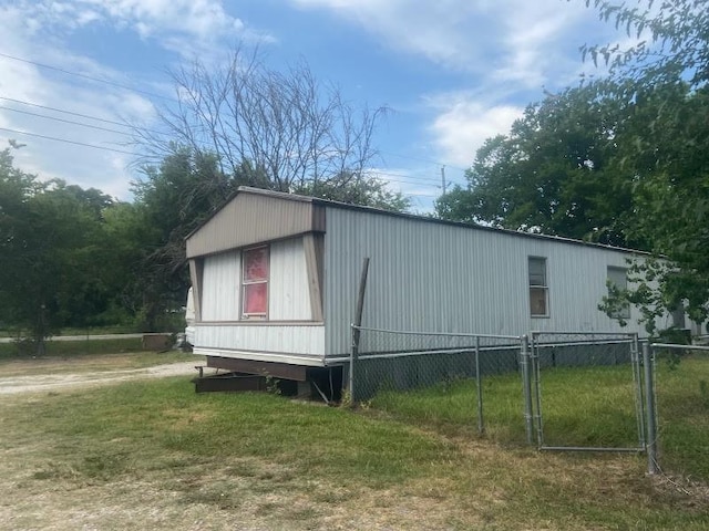 view of side of home with a yard