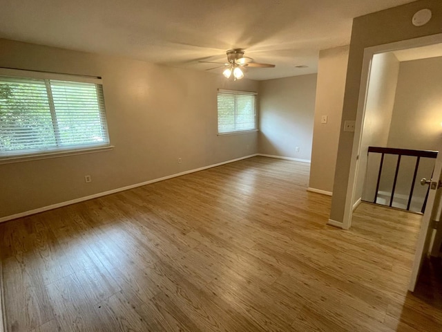 unfurnished room with hardwood / wood-style floors and ceiling fan