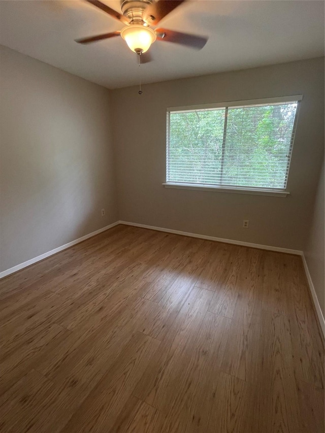 spare room with hardwood / wood-style flooring and ceiling fan