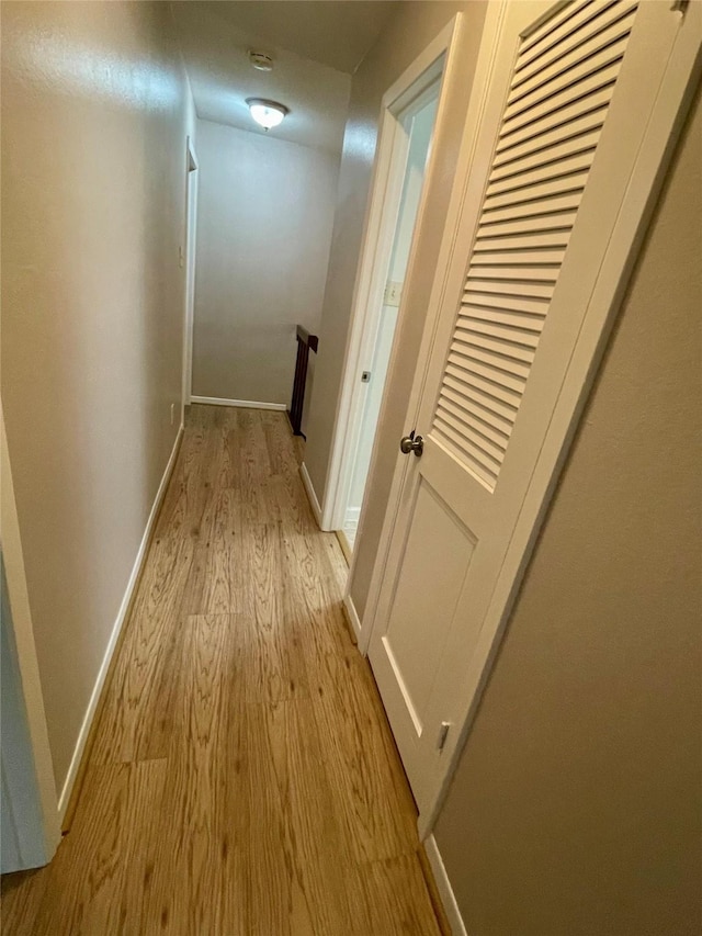 corridor with light hardwood / wood-style flooring