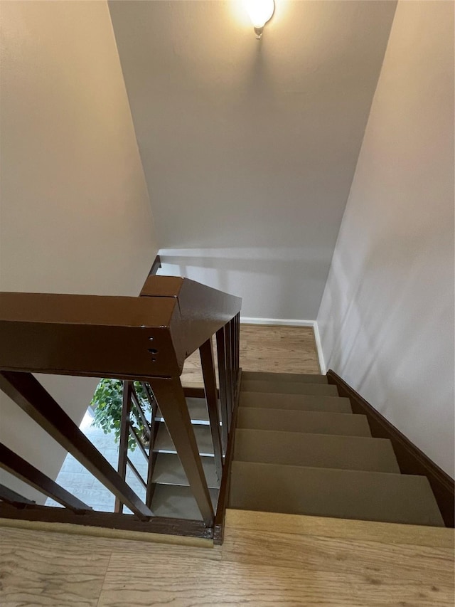 staircase with hardwood / wood-style flooring