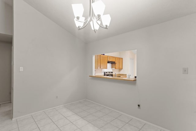 unfurnished room with light tile patterned floors and a chandelier