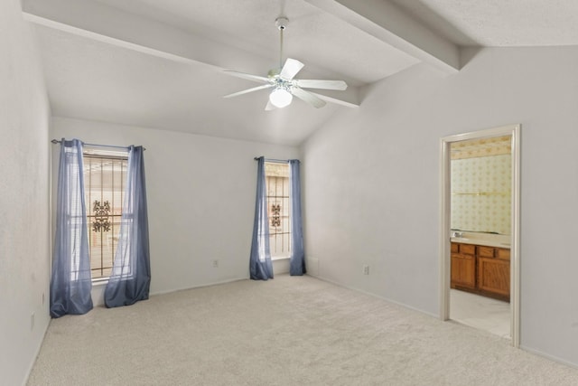 spare room with light carpet, ceiling fan, and lofted ceiling with beams