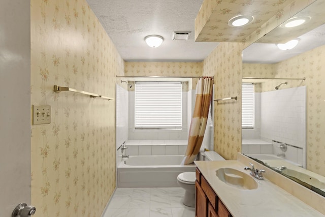 full bathroom featuring a textured ceiling, vanity, toilet, and shower / bath combo with shower curtain