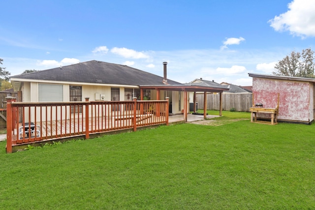 back of house featuring a patio area, a yard, and a wooden deck