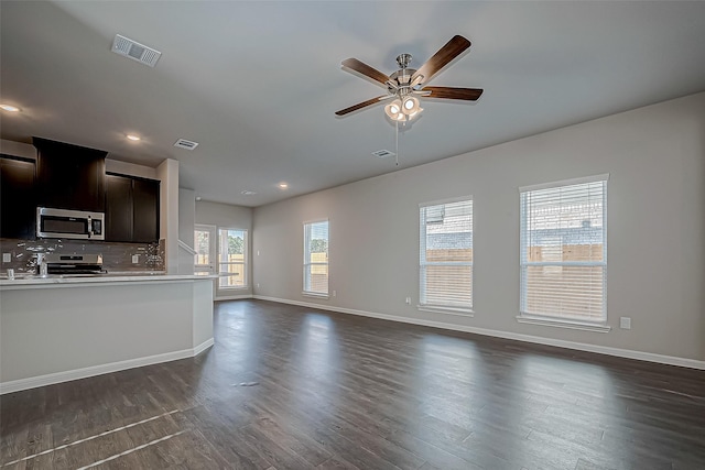 unfurnished living room featuring dark hardwood / wood-style floors and ceiling fan