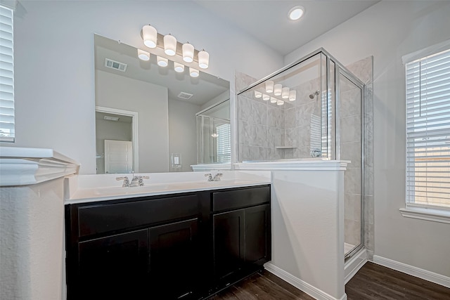 bathroom featuring vanity, hardwood / wood-style flooring, and an enclosed shower