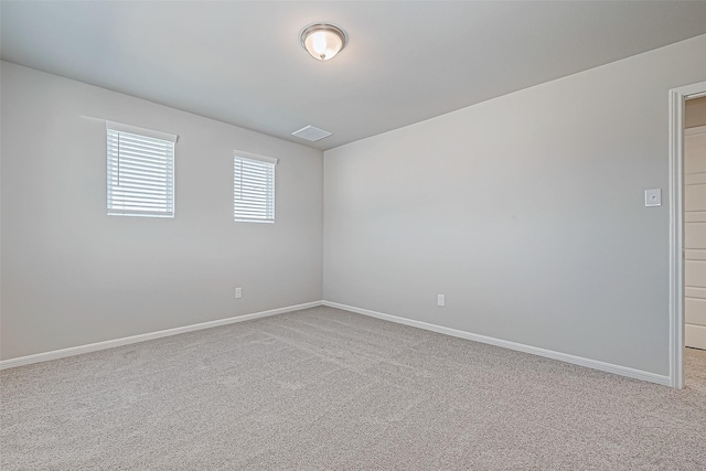 spare room with light colored carpet