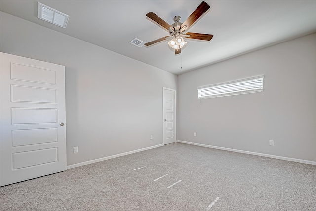 carpeted empty room featuring ceiling fan