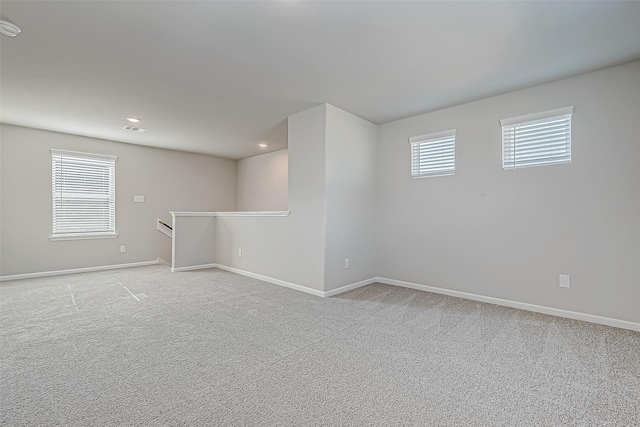 basement with light colored carpet and a healthy amount of sunlight