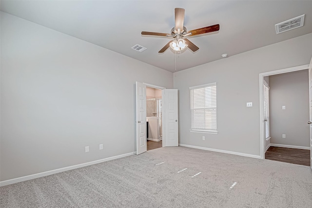 unfurnished bedroom featuring carpet, ceiling fan, and ensuite bathroom