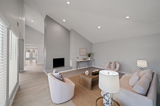 living room with a fireplace, light wood-type flooring, and high vaulted ceiling