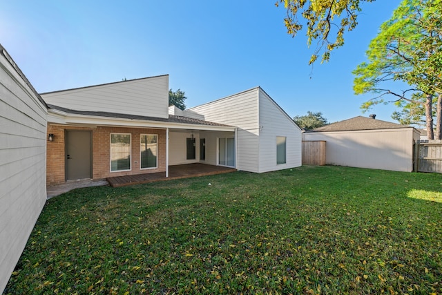 rear view of property with a lawn and a patio area