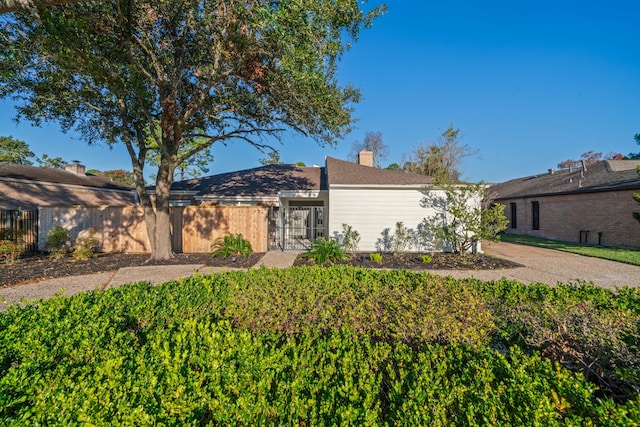 view of front of property with a chimney and fence