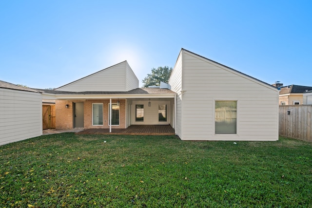 rear view of house featuring a yard