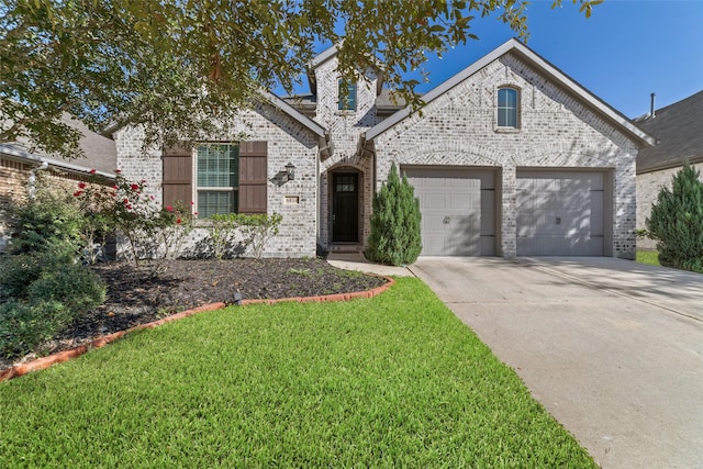 view of front facade with a front yard and a garage