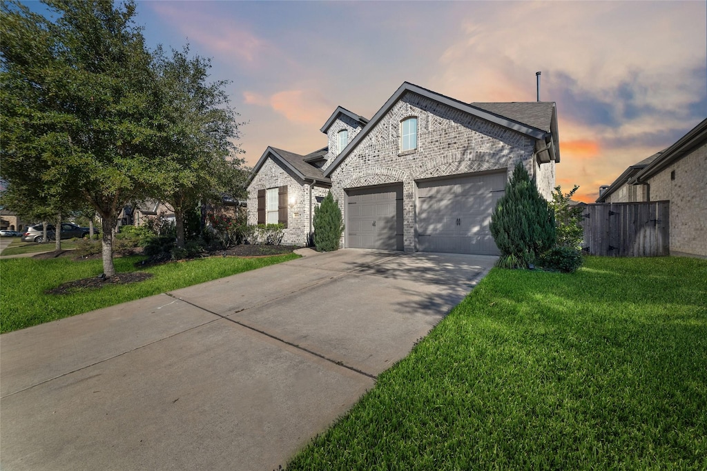 view of front facade with a yard and a garage