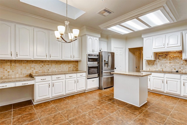 kitchen with white cabinets, a kitchen island, stainless steel appliances, decorative backsplash, and hanging light fixtures