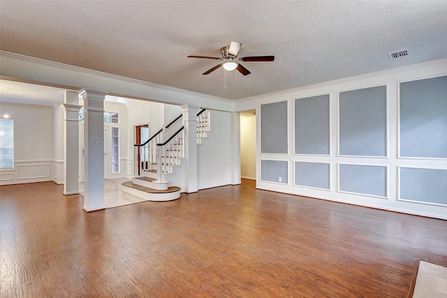 interior space featuring ceiling fan with notable chandelier, a textured ceiling, wood-type flooring, and ornamental molding