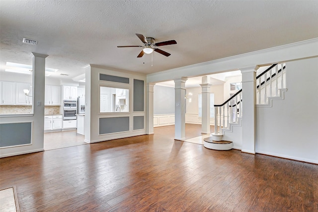 unfurnished living room with ceiling fan, hardwood / wood-style floors, and ornamental molding