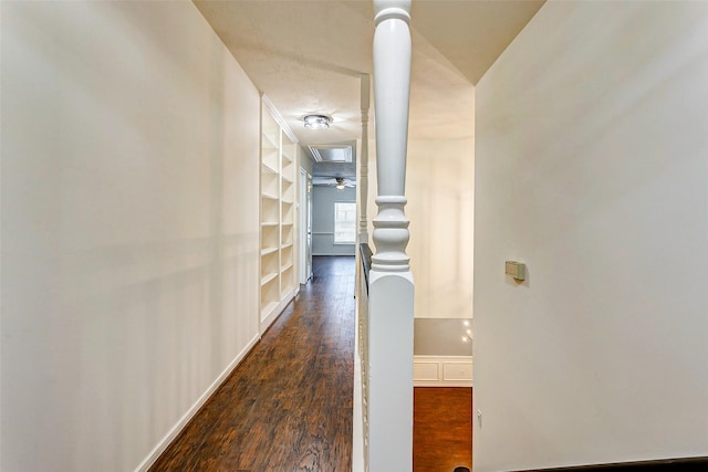 hall with built in features and dark hardwood / wood-style flooring