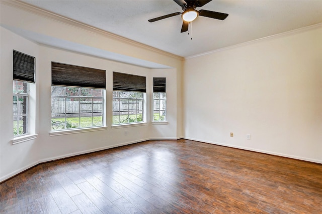 spare room featuring ceiling fan, a healthy amount of sunlight, ornamental molding, and dark hardwood / wood-style floors