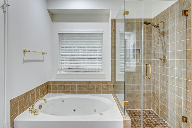 bathroom featuring shower with separate bathtub