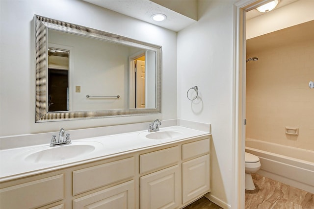 full bathroom featuring toilet, vanity, and tiled shower / bath combo