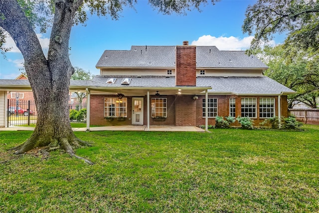 rear view of property featuring a patio area, a lawn, and ceiling fan